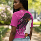 Woman wearing a pink t-shirt with a graphic design outdoors
